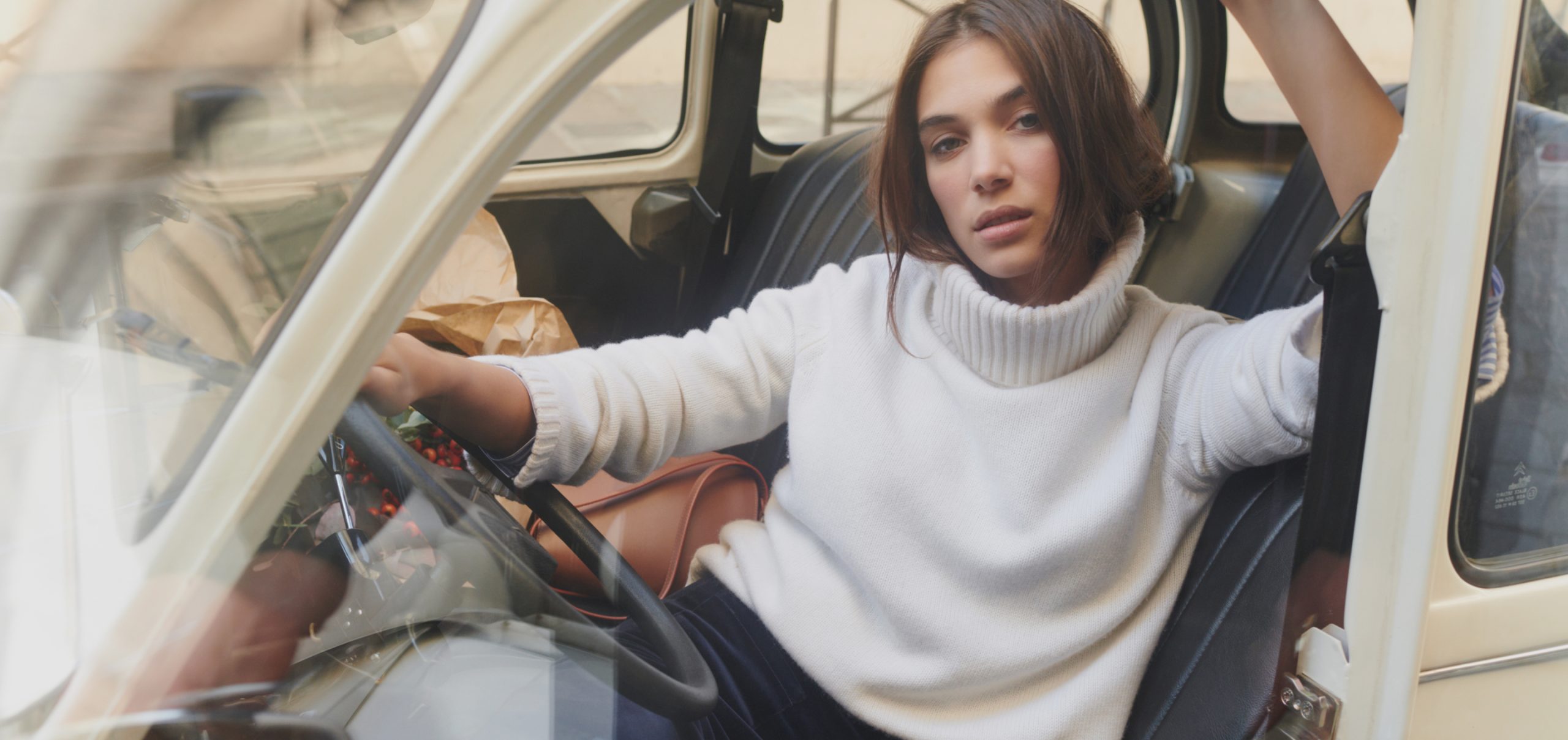 Woman wearing white WYSE London jumper